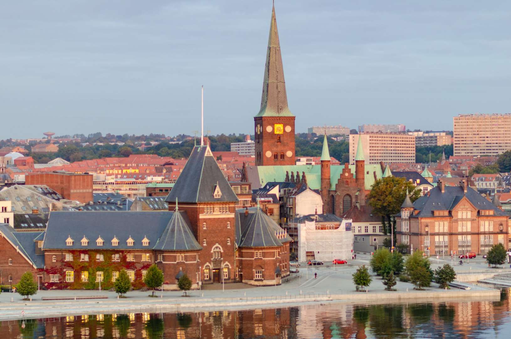 Eine Stadtlandschaft mit einer Kirche und einem Fluss im Vordergrund