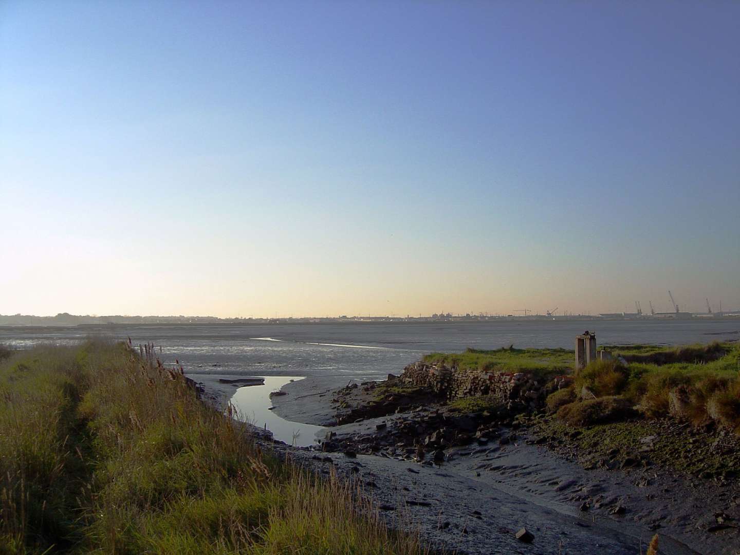 Ein Fluss fließt durch einen Feldweg ins Meer