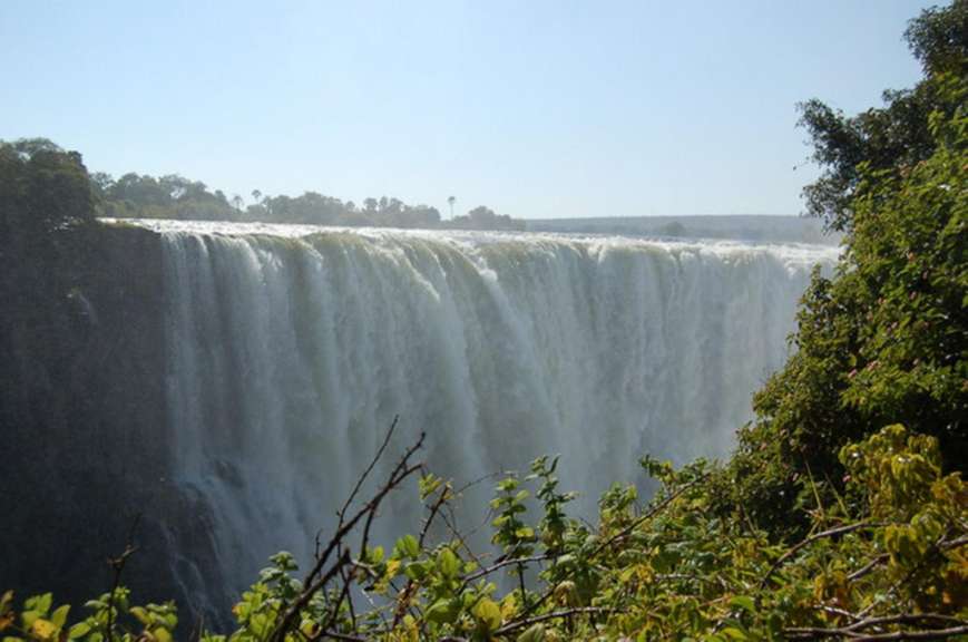 Ein Wasserfall mit einem blauen Himmel im Hintergrund