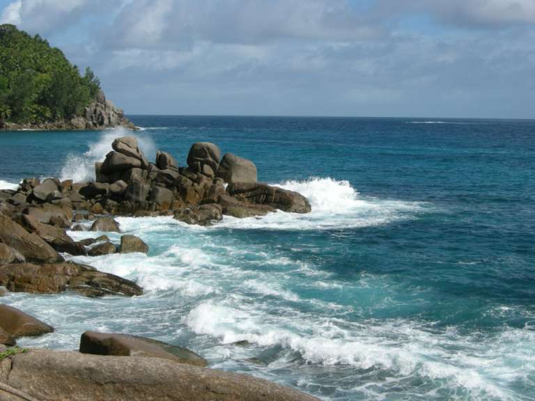 Wellen brechen an einem felsigen Ufer ins Meer