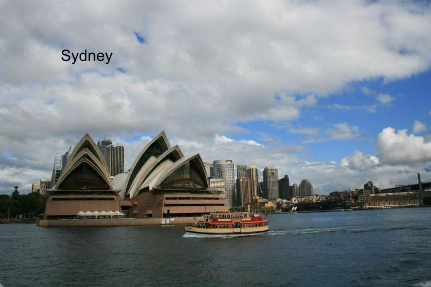 Ein Bild von der Stadt sydney mit einem Boot im Vordergrund