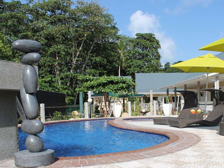 Ein großer Swimmingpool mit Liegestühlen und Sonnenschirmen