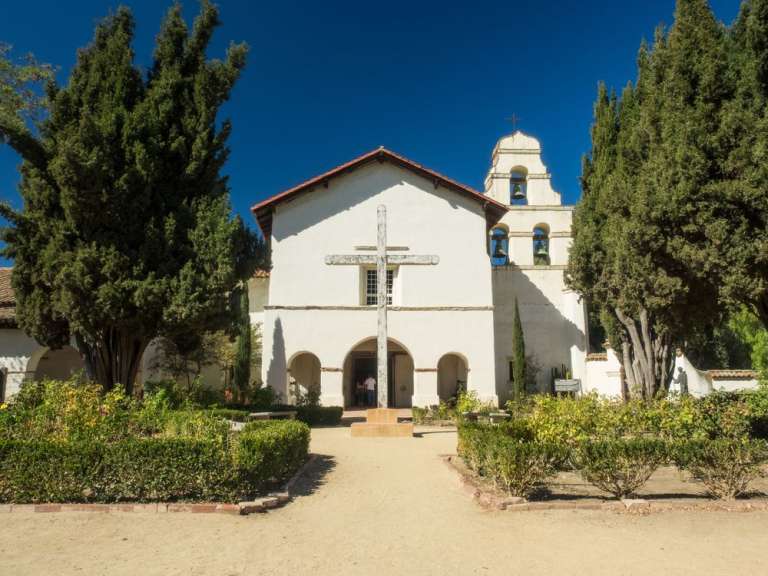 Eine weiße Kirche mit einem großen Kreuz davor