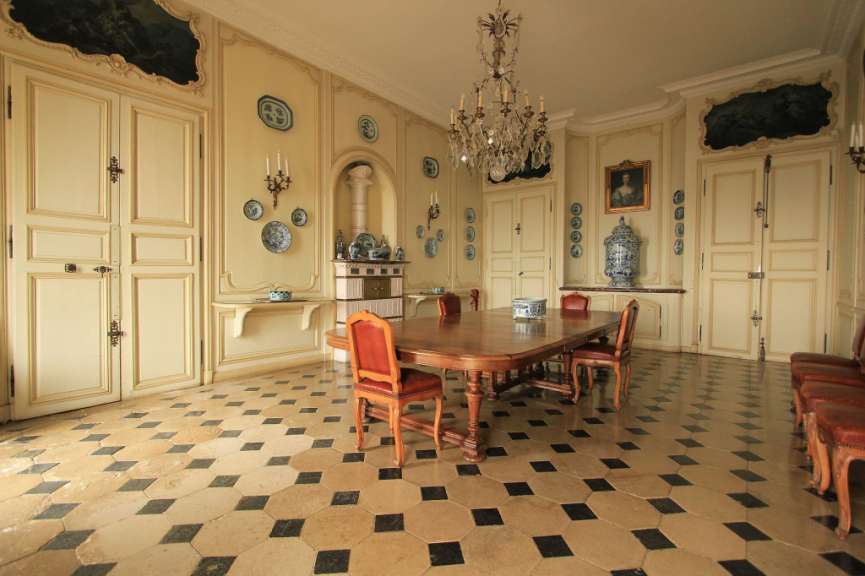 Ein Esszimmer mit einem Tisch und Stühlen und einem Kronleuchter