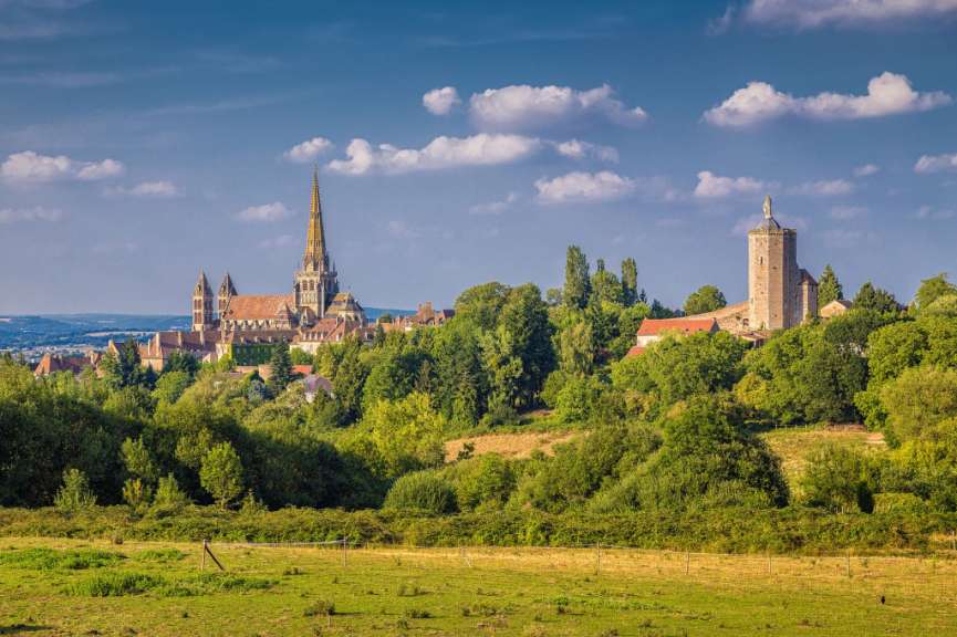 Ein kleines Dorf mit einer Kirche und einem Turm in der Ferne