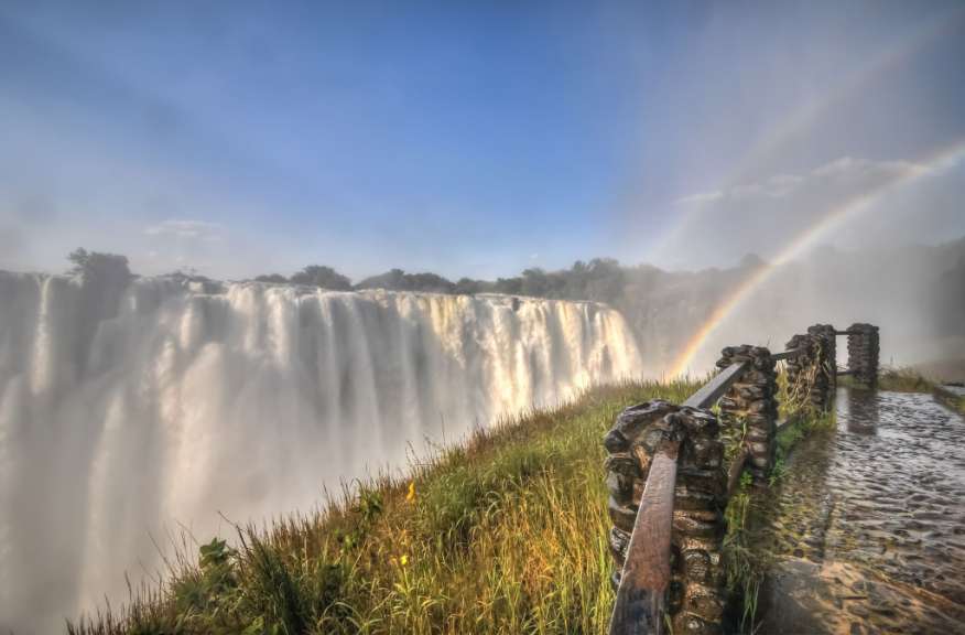 Ein Wasserfall mit einem Regenbogen in der Ferne