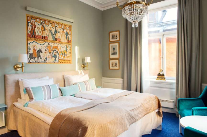 Ein Schlafzimmer mit einem Bett und einem Gemälde an der Wand