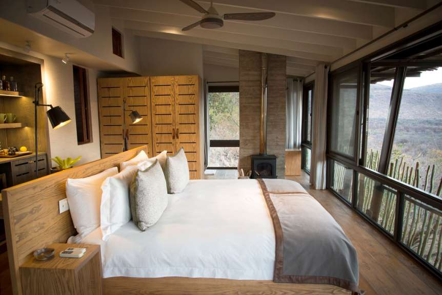 Ein Schlafzimmer mit einem großen Bett und vielen Fenstern