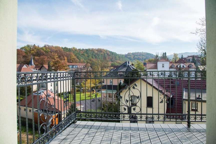 Ein Balkon mit einem schmiedeeisernen Geländer und einem Blick auf eine Stadt