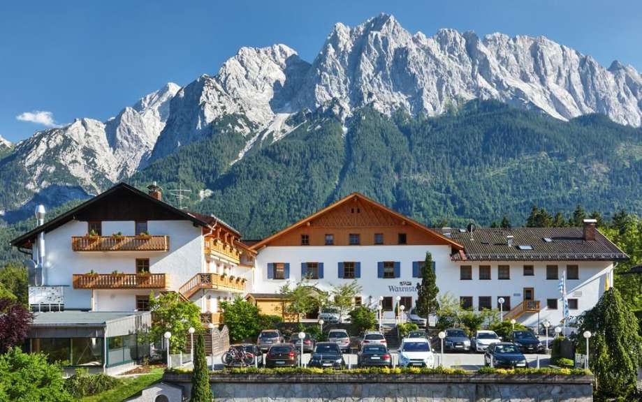 Ein großes weißes Hotel mit einem Berg im Hintergrund