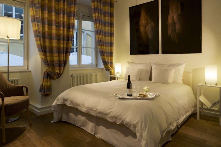 Ein Bett mit einer Flasche Wein und einem Tablett darauf