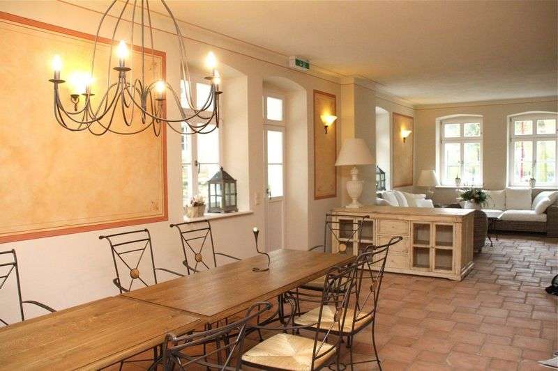 Ein Wohnzimmer mit einem Tisch und Stühlen und einem Kronleuchter