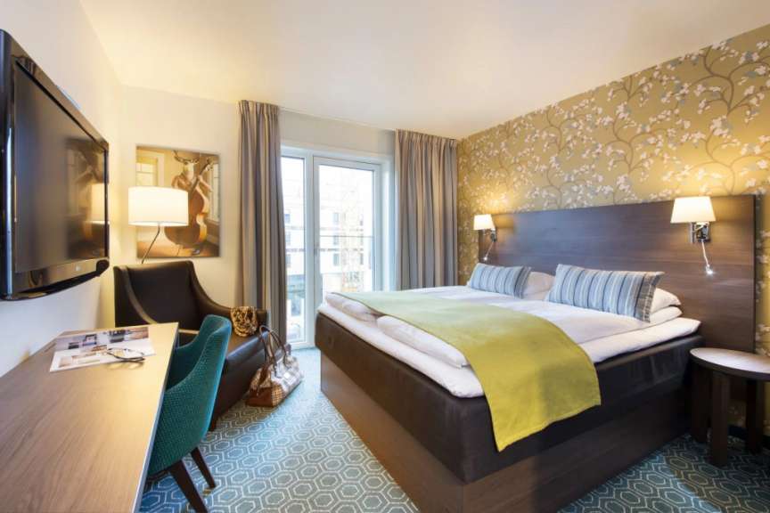 Ein Hotelzimmer mit einem Bett und einem Fernseher