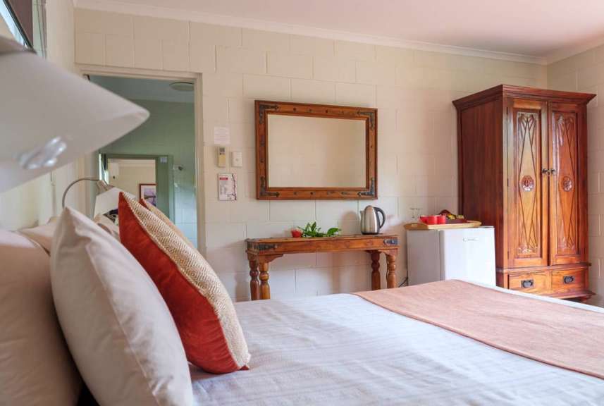 Ein Schlafzimmer mit einem Bett, einem Schrank und einem Spiegel