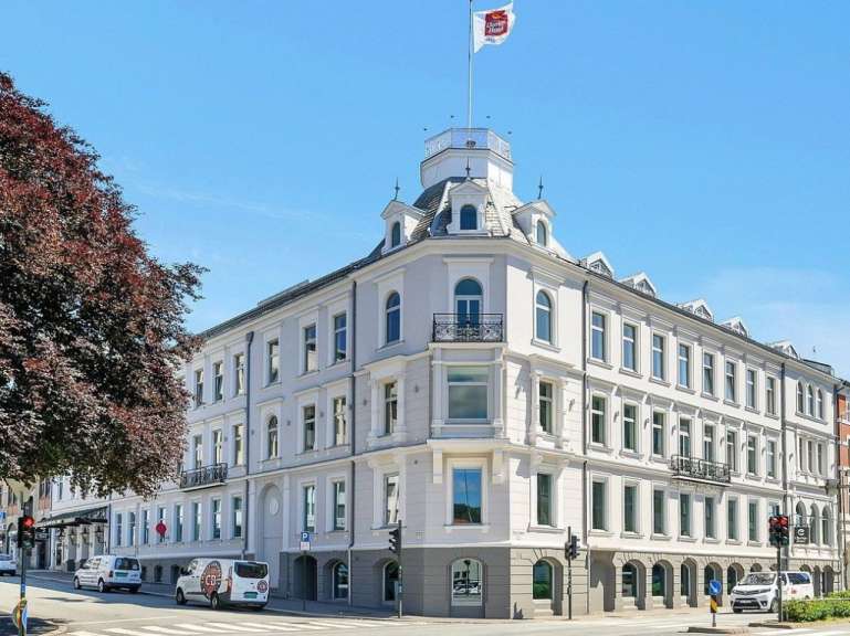 Ein großes weißes Gebäude mit einer roten Fahne darauf