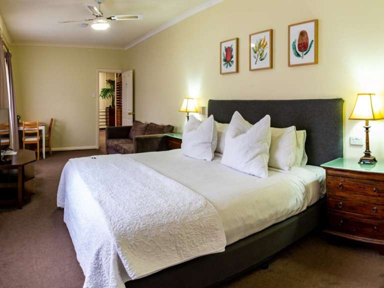 Ein Schlafzimmer mit einem Bett und drei Bildern an der Wand