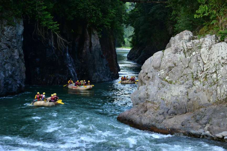 Eine Gruppe von Menschen fährt in einem Fluss mit Rädern