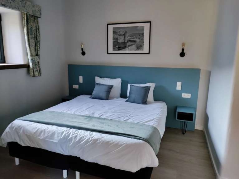 Ein Schlafzimmer mit einem Bett und einem Gemälde an der Wand