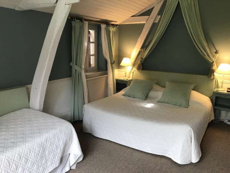 Ein Schlafzimmer mit zwei Betten und einem Himmelbett