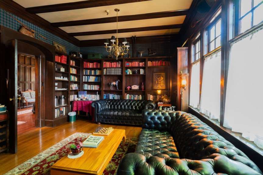 Ein Wohnzimmer mit Ledersofas und Bücherregalen
