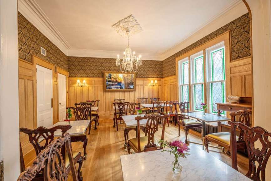 Ein Esszimmer mit Tischen und Stühlen und einem Kronleuchter