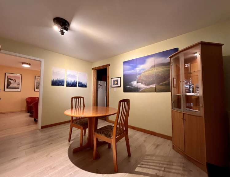 Ein Esszimmer mit einem Tisch und Stühlen und Bildern an den Wänden