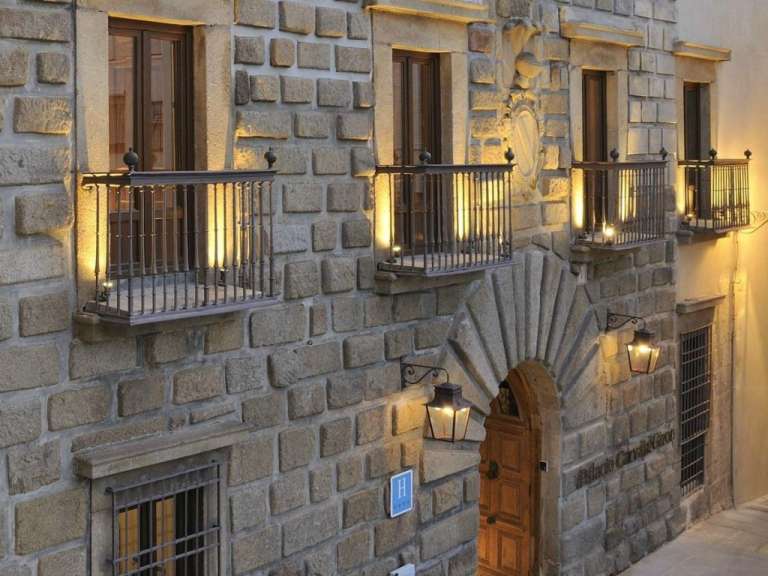 A brick building with balconies and a sign that says hotel