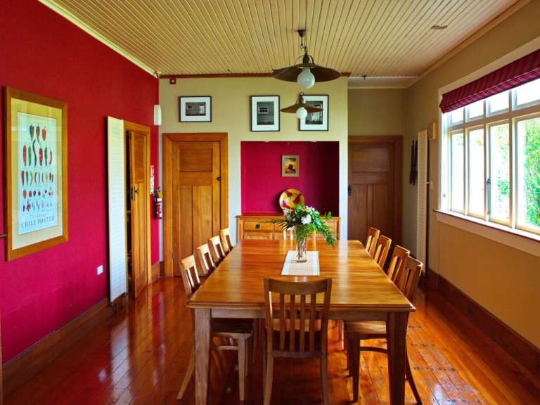 Ein Esszimmer mit einem langen Holztisch und Stühlen