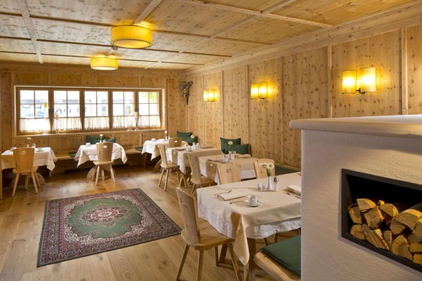 Ein Esszimmer mit Holzwänden und Tischen und Stühlen