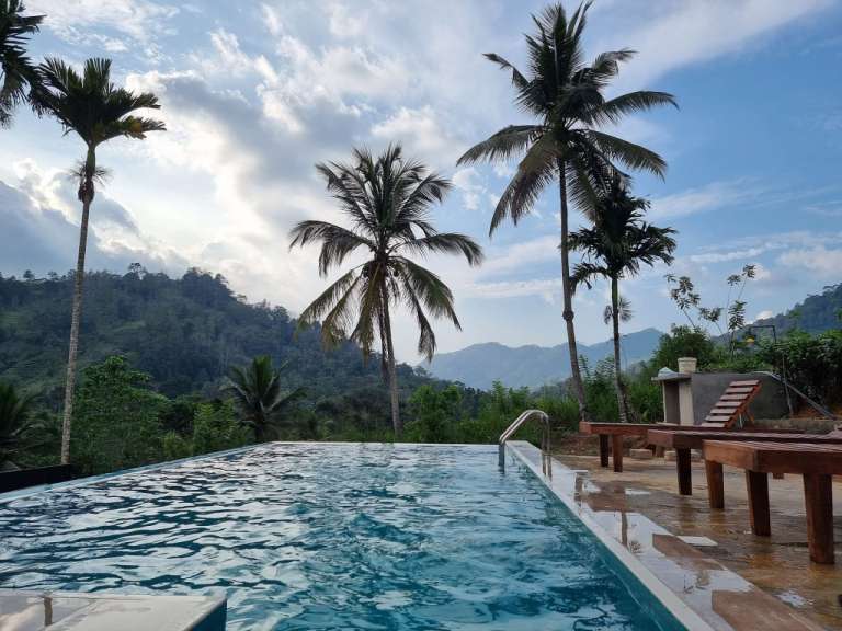 Ein Pool mit Palmen und Bergen im Hintergrund