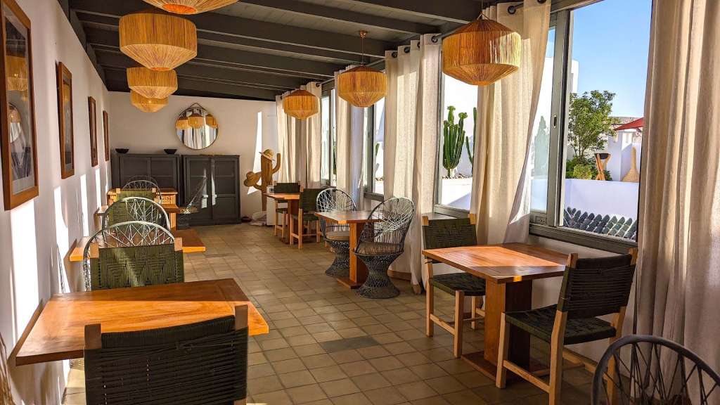 Ein langes Esszimmer mit Holztischen und Stühlen