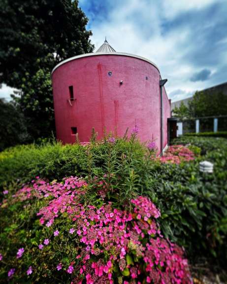 Ein rosa Gebäude mit der Nummer 12 darauf