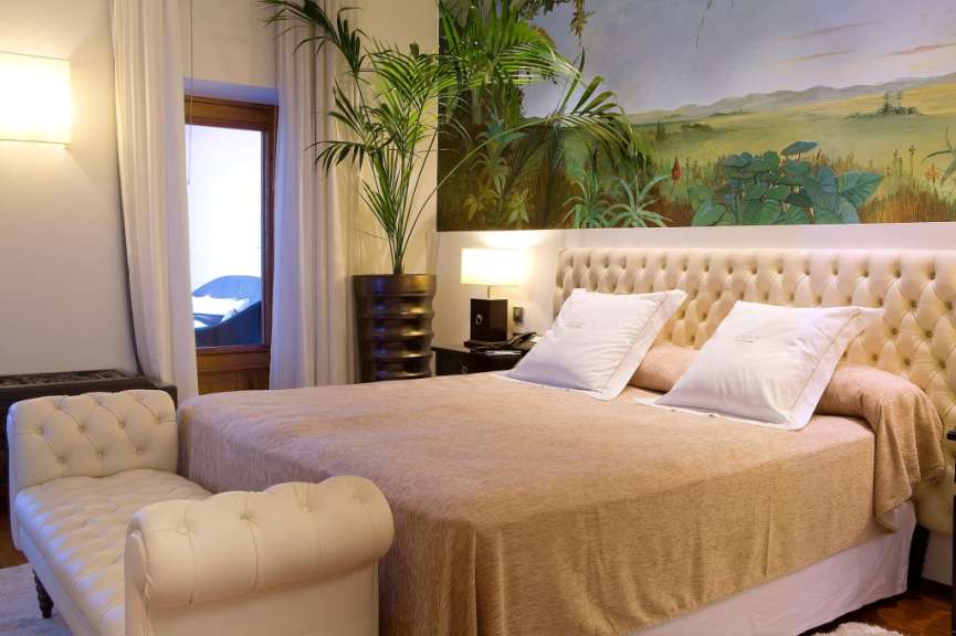 Ein Schlafzimmer mit einem Bett und einem weißen Stuhl