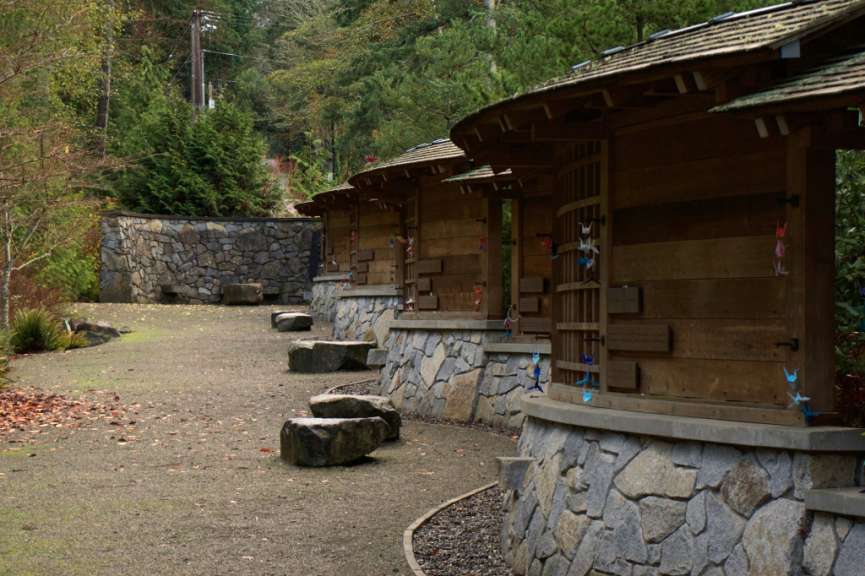 Eine Reihe von hölzernen Gebäuden neben einer Steinmauer