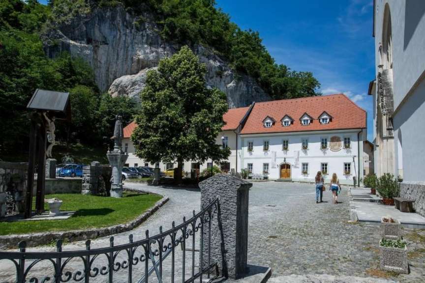 Ein paar leute gehen vor einem gebäude mit einem roten dach