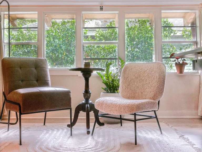 Ein Wohnzimmer mit zwei Stühlen und einem Tisch
