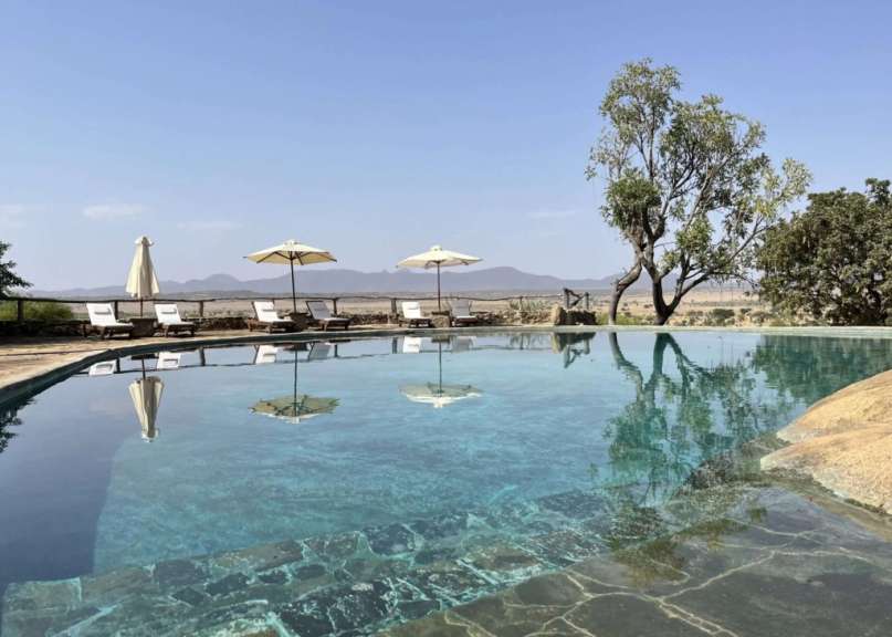 Ein großer Swimmingpool mit Liegestühlen und Sonnenschirmen
