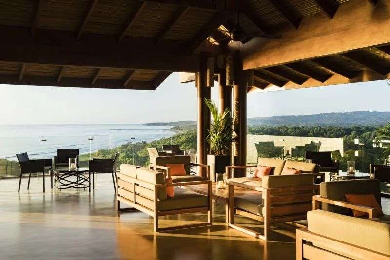 Ein Wohnzimmer mit Möbeln und einem Tisch mit Blick auf das Meer