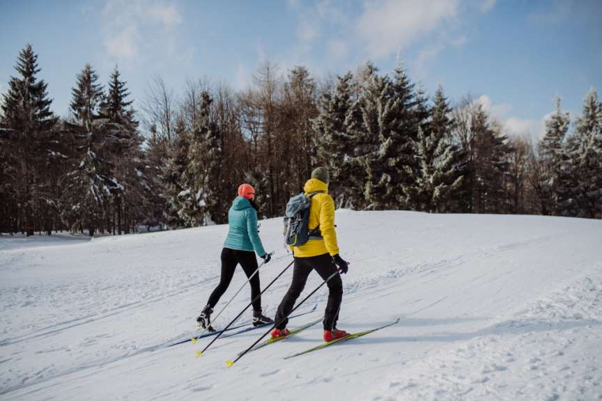 Ein Mann und eine Frau skifahren im Schnee