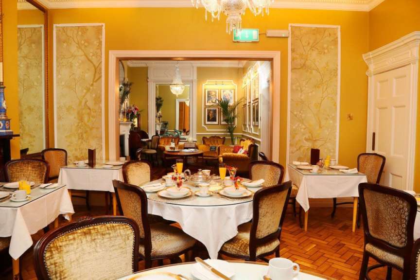 Ein Esszimmer mit vielen Tischen und Stühlen