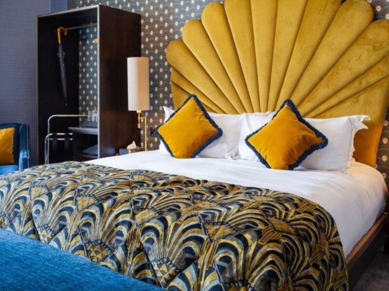 Ein Hotelzimmer mit einem Bett und einem gelben Kopfteil