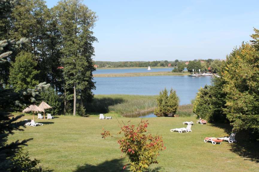 Liegestühle liegen auf einer Wiese in der Nähe eines Sees