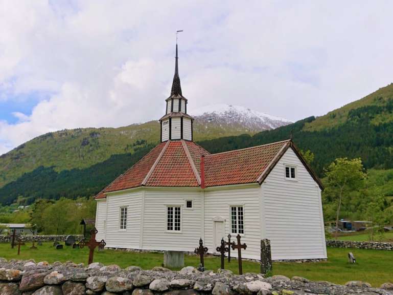 Eine kleine weiße Kirche mit einem roten Dach und einem Glockenturm