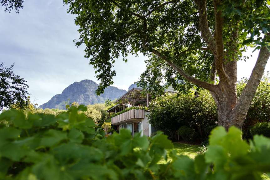 Ein Haus mit einem Balkon und einem Berg im Hintergrund