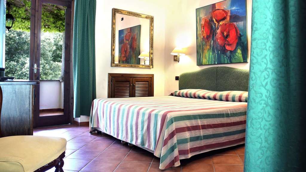 Ein Schlafzimmer mit einem Bett und einem Gemälde an der Wand