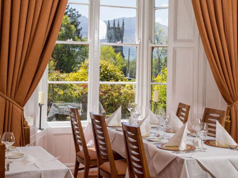 Ein Esszimmer mit einem Tisch und Stühlen und einem Fenster