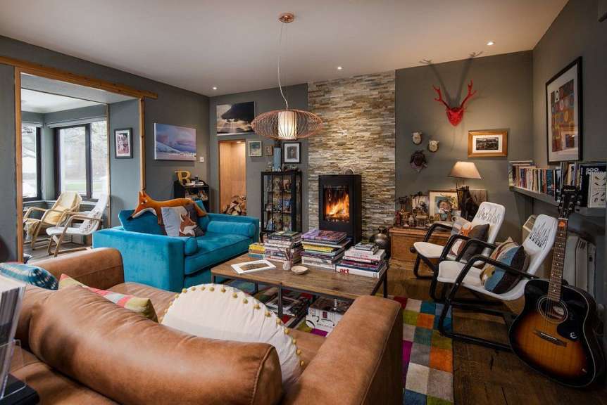 Ein Wohnzimmer mit einem blauen Couch und einer Gitarre