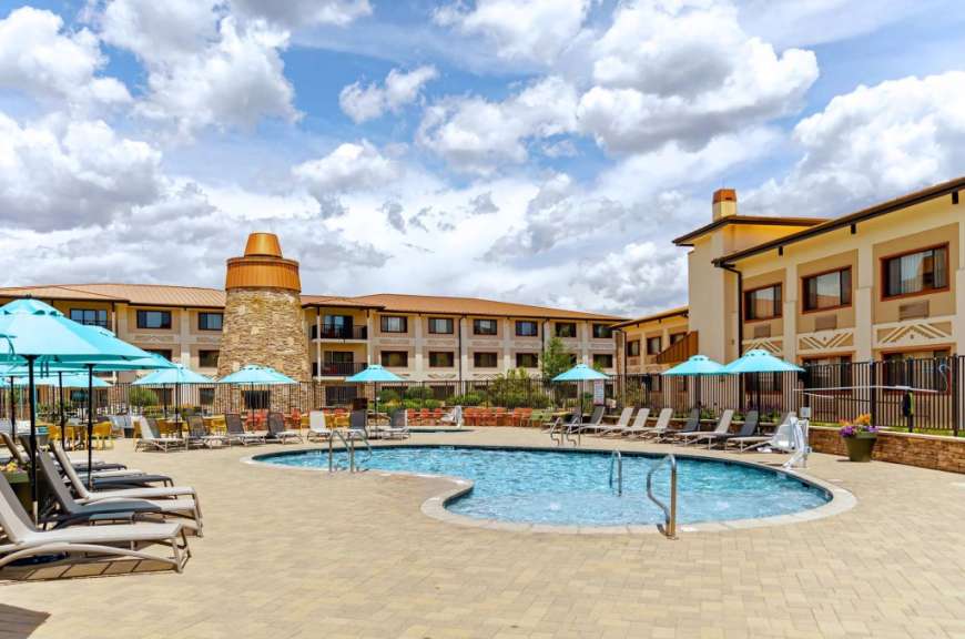 Ein Hotel mit einem großen Pool und vielen Sonnenschirmen