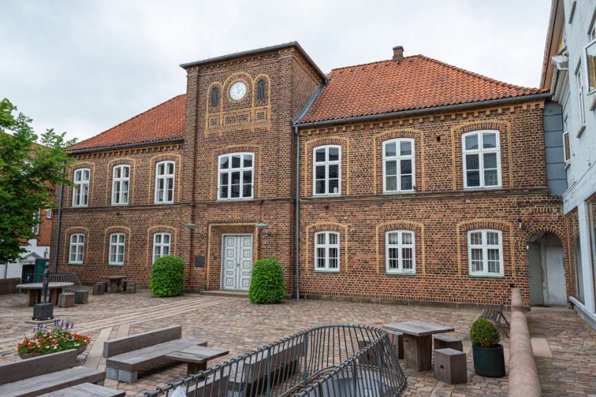 Ein großes Backsteingebäude mit einer Uhr an der Spitze