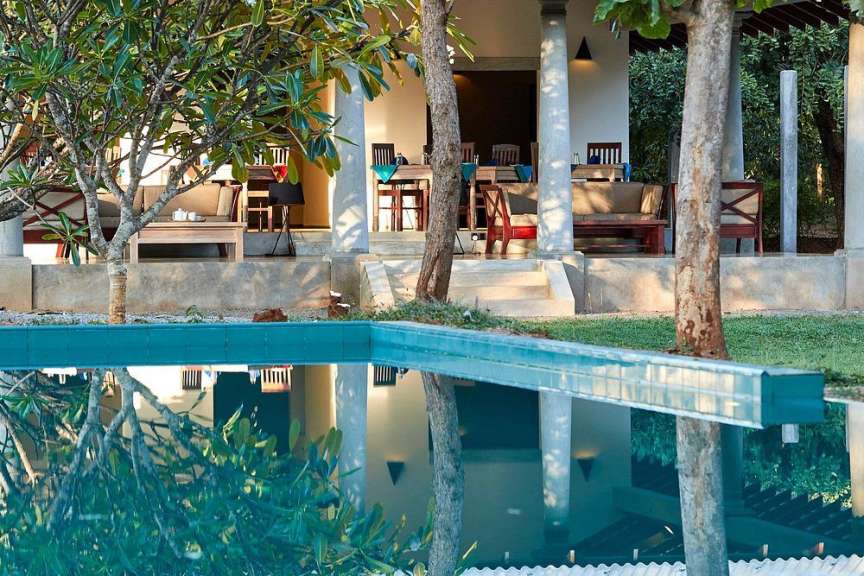 Ein Haus mit einem Pool und einer Veranda dahinter